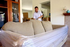 movers packing sofa