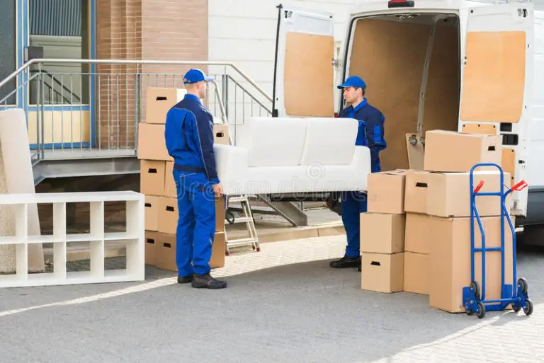 movers carrying sofa outside truck street full length young male 77511013